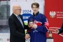 Brynley Capps receives his forward of the tournament award. Image: IIHF