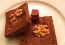 Celia’s delicious raw fudge brownies garnished with walnut