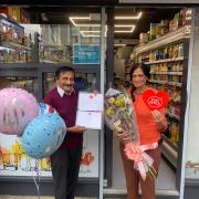 Hasmukh Parikh, celebrating over 40 years as postmaster at Battersea Bridge post office with his family and colleagues