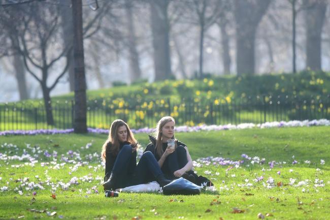 People enjoying the sunshine in a London park