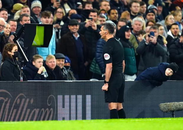 Wandsworth Times: Referee Andre Marriner checks a penalty decision on VAR during the Carabao Cup Semi Final, second leg match at the Tottenham Hotspur Stadium, London.
