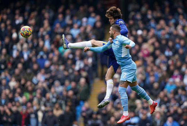 Chelsea's Marcos Alonso (left) and Manchester City's Kyle Walker battle for the ball during the Premier League match at Etihad Stadium, Manchester.