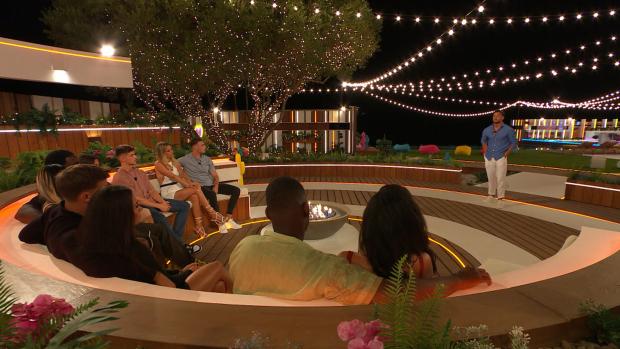 Wandsworth Times: The Islanders gather at the fire pit for Davide's decision on Love Island, tonight at 9pm on ITV2 and ITV Hub. Episodes are available the following morning on BritBox. Credit: ITV