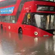 Buses in flood water in Battersea, south London (Hebe Campbell/PA)