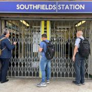 Passengers wait for the entrance gates to open at Southfields underground station in south London, the day after members of the Rail, Maritime and Transport union (RMT) from 14 train operators went on strike over jobs, pay and conditions / Image: PA